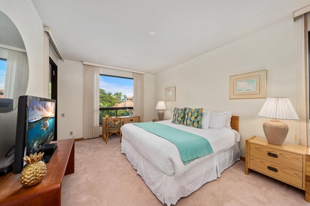 Drift to sleep in your tropical bedroom with turquoise accents, bamboo furnishings, and peaceful garden views through your private window.