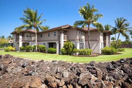 Beautiful lawn and elegant lanais surrounded by lava rock accents.