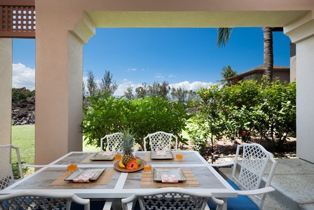 - Dine in paradise with this outdoor table setup featuring fresh tropical fruit and vibrant tableware - Surrounded by swaying trees and island breezes, it’s perfect for any meal - Clear blue skies and rich greenery create a true Hawaii experience