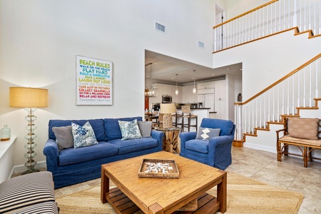 Living room with vaulted ceiling and tall windows