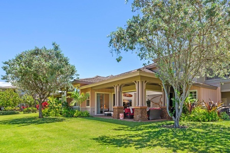 Side view of home with covered patio and landscaped yard.