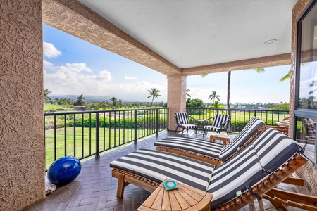 Unwind on your private balcony with striped loungers overlooking lush golf course greens