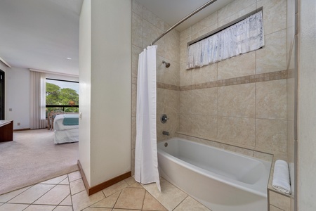 Your spacious bathroom features elegant tile work and a relaxing tub, perfect for unwinding after exploring.