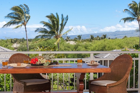 - Scenic balcony dining with vibrant palm trees swaying in the breeze   - Fresh tropical fruit and drinks create a refreshing island setting   - Uninterrupted views of beautiful greenery and distant mountains beyond