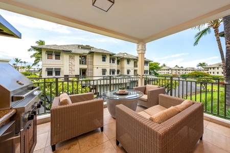 Settle into your private balcony with resort-style seating and a built-in grill, overlooking lush tropical gardens and swaying palms that frame this peaceful island escape.