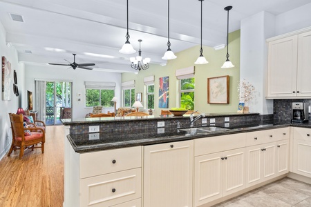 Full kitchen with breakfast bar, granite counters, and modern appliances