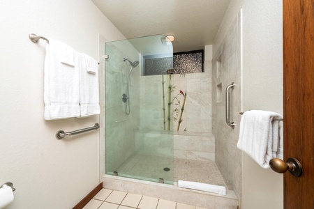 Step into your spacious glass-enclosed shower with luxurious marble accents and premium fixtures for a spa-like experience.