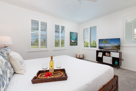 - Cozy king suite styled with a breakfast tray, plush pillows, and calming decor - TV positioned across the bed makes evenings and mornings more enjoyable - Shuttered windows offer privacy while bringing in natural light and views