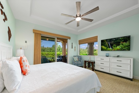 Your peaceful bedroom sanctuary features tropical breezes from the ceiling fan and stunning garden views through sliding doors to your private balcony.