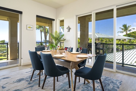 - Dining area with seating for six surrounded by windows and views   - Light wood table pairs beautifully with deep blue upholstered chairs   - Easy access to outdoor dining on the lanai for ocean view meals
