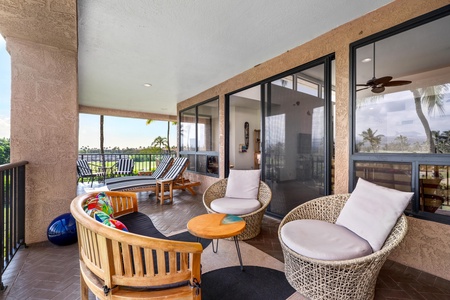 Unwind on your private covered lanai with comfortable seating overlooking tropical golf course views—perfect for morning coffee or sunset relaxation.