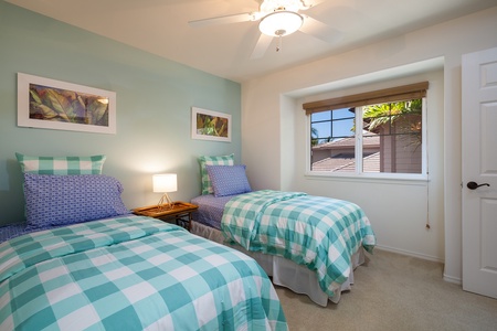 - Cheerful twin bedroom perfect for kids or friends with playful checkered bedding - Large window lets in soft light while framing tropical views - Coordinated wall art and soft colors create a fresh, fun, and restful space