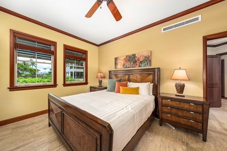 Drift off in this serene bedroom with elegant wood furnishings, crisp linens, and a ceiling fan to keep you cool. Two windows frame glimpses of tropical palms outside your door.