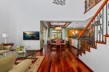 - Open concept layout with dining area between kitchen and living room - Elegant tray ceiling with chandelier highlights the hardwood floors - Perfect for entertaining with seamless indoor outdoor flow