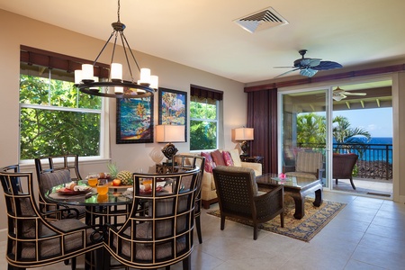 - Open concept dining and living space filled with light and surrounded by tropical views - Stylish chandelier, glass table, and vibrant wall art create an upscale island vibe - Ideal for gathering, dining, and relaxing with family and friends