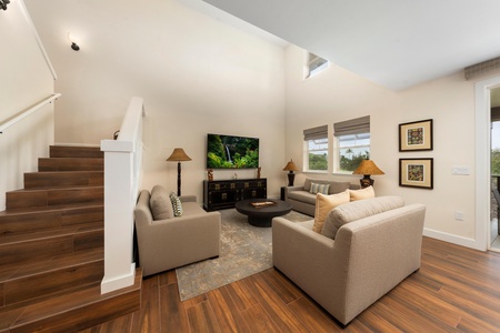 Sink into plush seating in your bright living space, where warm wood floors and natural light create the perfect retreat.