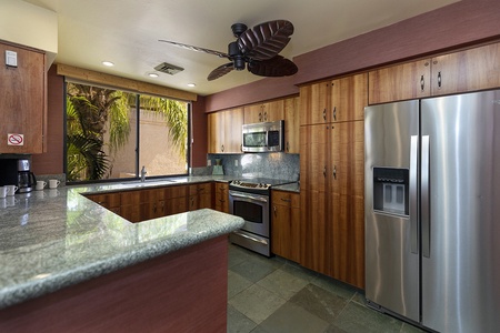 Well equipped kitchen with stainless steel appliances and abundant cabinet storage.