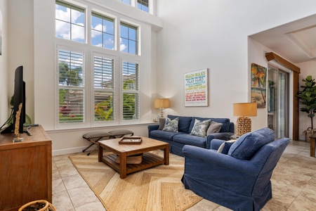Living room with vaulted ceiling and tall windows