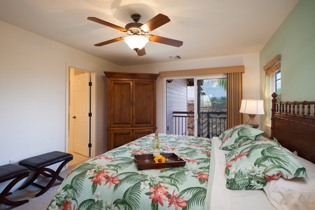 - King bedroom offers tropical style, direct balcony access, and cozy wood furnishings - Ceiling fan keeps the breeze flowing while you unwind or read - Classic armoire adds charm and function, with a tray ready for breakfast in bed