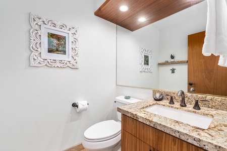 Your elegant powder room combines luxury granite counters with warm wood accents.