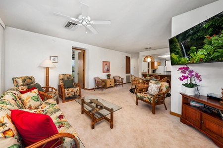Unwind in your spacious living room with tropical bamboo furniture, large-screen TV, and refreshing ceiling fan overhead.