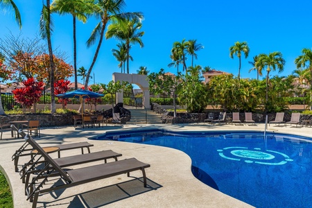 Resort pool with plenty of loungers.