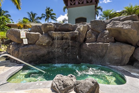 Natural stone hot tub with cascading waterfall creates your private tropical oasis beneath swaying palms.