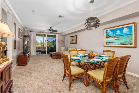 Gather around your elegant dining table for memorable meals, with tropical artwork and sliding doors opening to your private outdoor space.