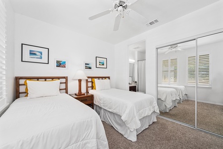 - Twin bedroom with mirrored closet doors for easy storage and a sense of space - Bright windows and neutral design create a welcoming and airy atmosphere - Convenient ensuite access makes this a private and comfortable space