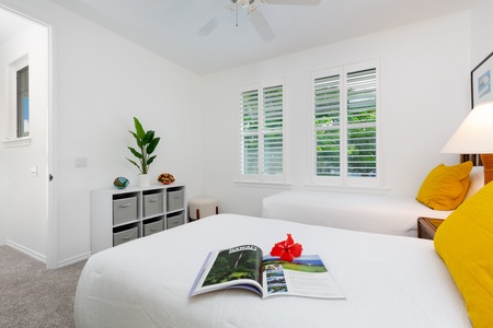 - Simple twin room with white bedding accented by natural light and leafy views - Functional storage cubes and decor pieces bring both style and utility - Ideal for younger guests or travel companions needing a cozy setup