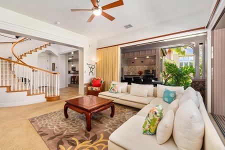 - Gather in the heart of the home with plush seating and open layout design - View flows effortlessly to the kitchen, stairs, and outdoor lanai beyond - Vibrant space perfect for relaxing after beach days with your group