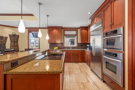 Step into your gourmet kitchen with warm wood cabinetry, granite countertops, and stainless steel appliances ready for your culinary adventures.