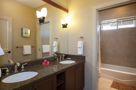 - Bright and functional bathroom with granite dual vanities and soft wall sconces for ideal lighting - Private water closet with a shower tub combo offers added convenience - Clean, spacious, and perfectly set up for shared routines