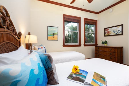 - Guest bedroom with twin beds, tropical pillows, and cheerful decor   - Large windows frame palm tree views and bring in natural light   - Open book and fresh hibiscus flower add a welcoming touch to the space