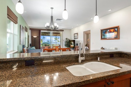 Full kitchen with breakfast bar, granite counters, and stainless steel appliances