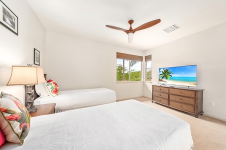 Drift off to sleep in your bright bedroom with twin beds, tropical ceiling fan, and flatscreen TV for cozy evenings in.