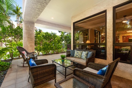 Your private terrace welcomes you with plush wicker seating and tropical garden views, perfect for morning coffee or evening relaxation.