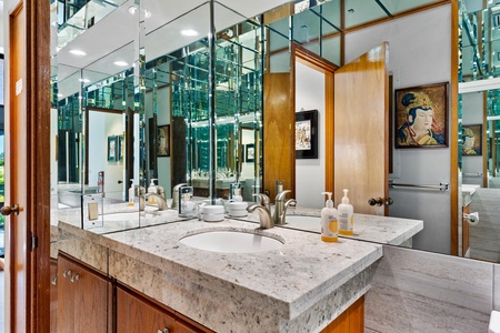 - Stunning vanity with modern fixtures, granite countertop, and stylish mirrored walls - Well lit space provides excellent visibility for grooming and makeup - Bold and elegant, this bathroom offers both function and visual impact
