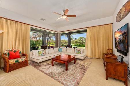 - Comfortable sectional faces beautiful garden views framed by large windows - Neutral tones and rich wood accents create an elegant and calming vibe - Natural light pours into this tranquil space for lounging and gathering