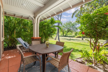 Unwind on your private covered patio with wicker dining set, surrounded by lush tropical gardens and swaying palms.