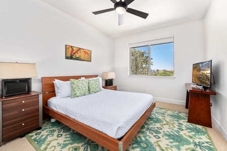 - Rest easy on the cozy bed with plush pillows and modern decor - Large window welcomes daylight and treetop views into the room - Ceiling fan, nightstands, and area rug add comfort and visual charm