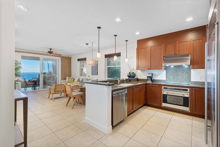 Your spacious kitchen flows seamlessly into the living area, where ocean views greet you through floor-to-ceiling windows.