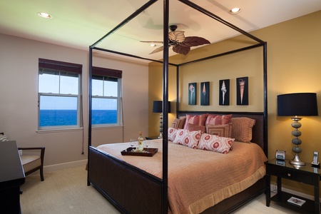 - Elegant king bedroom with four poster canopy bed and breathtaking views of the Pacific - Beach inspired decor and rich colors create a serene tropical sanctuary - Wake up to ocean blues just outside your window in this peaceful retreat
