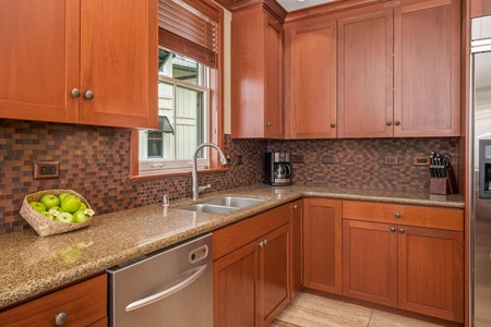 Your gourmet kitchen features warm cherry cabinetry, granite counters, and modern appliances—everything you need to prepare meals in comfort and style.