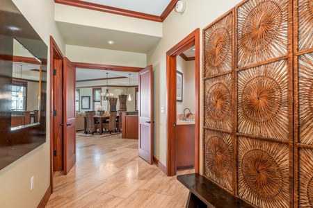 Step into a welcoming entryway with rich wood accents and tropical charm. The open flow guides you toward inviting dining and living spaces, setting the tone for your island escape.