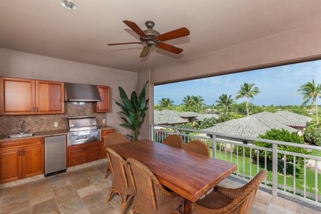 - Spacious covered lanai with six wicker chairs for group gatherings   - Rich wooden dining table offers a warm setting for shared meals   - Built in grill station and tropical views create a perfect cookout spot