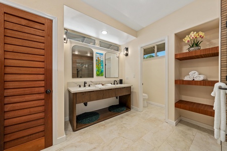 Your spacious bathroom features elegant double vanity, walk-in shower, and thoughtful built-in storage to keep your toiletries organized throughout your stay.