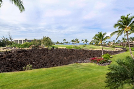 Championship golf course with dramatic lava rock features and tropical landscaping set against azure ocean views.
