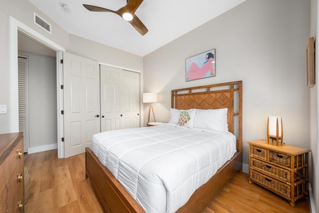 - Bright bedroom with comfortable bed framed in warm wood and neutral bedding - Closet space with double doors offers extra storage for personal belongings - Minimalist decor and soft lighting create a calm relaxing atmosphere
