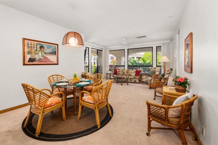 Relax in your tropical-inspired living space where rattan furniture and island artwork create the perfect atmosphere for dining and unwinding after beach adventures.